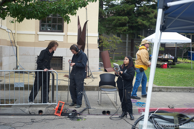 Tad and Ian setup video tripods as Karen practices with the Motoman