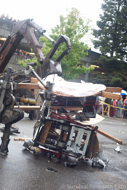 Big Arm finishes off the BugBot by dropping the Stick Wheel Robot on top of it